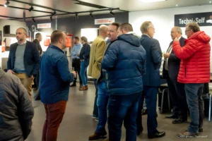 people chatting at the techniself showroom opening cocktail party